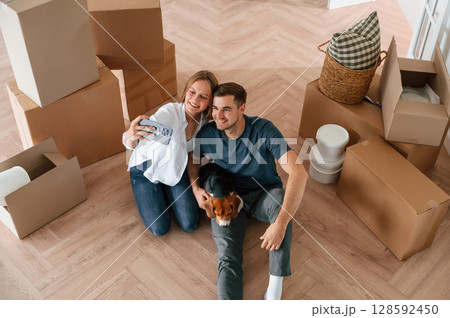 Looking at appartment. Young couple with dog are moving to new home 128592450