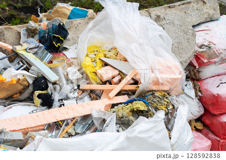 A large pile of trash featuring a plastic bag stuffed full of foam A large pile of trash featuring a plastic bag stuffed full of foam 128592838