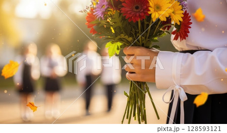 First Day of School Tradition - Hand Holding Seasonal Flowers 128593121