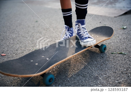 Close up view of skateboard riding by a young girl 128593187