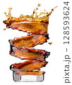 Spiral Splash of Cola in Glass Showing Motion and Energy 128593624