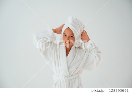 With towel on the head. Conception of beauty and self care. Young girl is in the studio 128593691