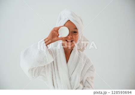 Holds a jar of face cream. Conception of beauty and self care. Young girl is in the studio Holds a jar of face cream. Conception of beauty and self care. Young girl is in the studio 128593694