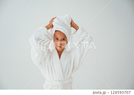 Having fun. With towel on head. Conception of beauty and self care. Young girl is in the studio Having fun. With towel on head. Conception of beauty and self care. Young girl is in the studio 128593707