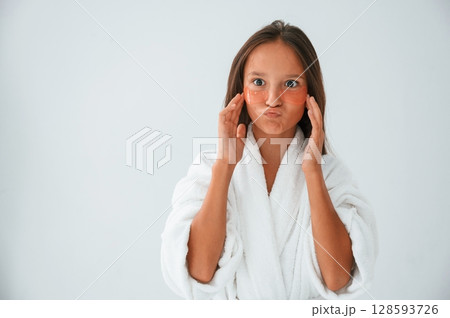 Young girl is in the studio using eye patches on the face 128593726