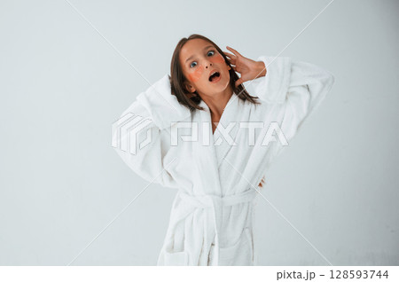 Standing and having fun. With eye patches. Conception of beauty and self care. Young girl is in the studio Standing and having fun. With eye patches. Conception of beauty and self care. Young girl is in the studio 128593744