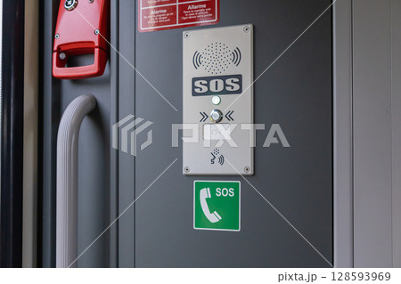Emergency call point with illuminated SOS button and intercom system, providing vital passenger assistance and immediate communication for safety in transit Emergency call point with illuminated SOS button and intercom system, providing vital passenger assistance and immediate communication for safety in transit 128593969