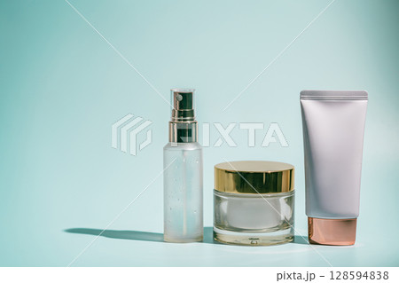 Three skincare products on blue Three skincare products on blue 128594838
