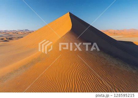 Majestic desert landscape with soaring sand dunes and clear azure sky 128595215