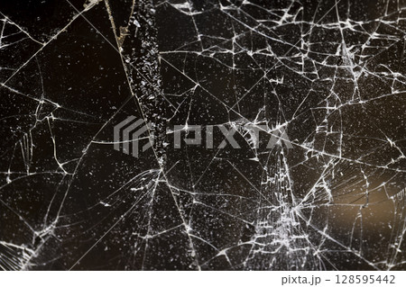 broken with a lot of damage of glass, thin glass broken into many pieces, close up 128595442