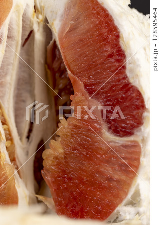 grapefruit with a thick peel cut into pieces, sweet and sour grapefruit fruit cut into several pieces and peeled from the yellow peel grapefruit with a thick peel cut into pieces, sweet and sour grapefruit fruit cut into several pieces and peeled from the yellow peel 128595464