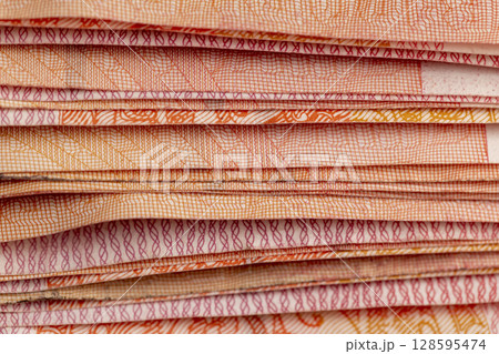One hundred yuan Chinese money together, large-denomination Red Chinese money stacked together on top, close up One hundred yuan Chinese money together, large-denomination Red Chinese money stacked together on top, close up 128595474