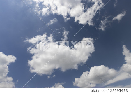 beautiful blue sky with lush white clouds in sunny bright weather 128595478