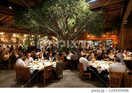 Festive atmosphere inside a unique restaurant with a large indoor tree Festive atmosphere inside a unique restaurant with a large indoor tree 128595606