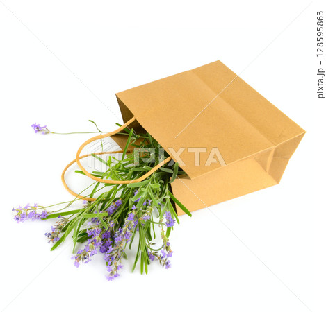 Bouquet of lavender flowers in a paper bag isolated on white. Bouquet of lavender flowers in a paper bag isolated on white. 128595863