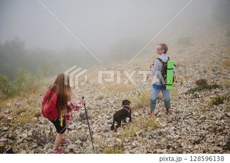 A Scenic Mountain Hike with Couple and Dog on a Misty Morning A Scenic Mountain Hike with Couple and Dog on a Misty Morning 128596138