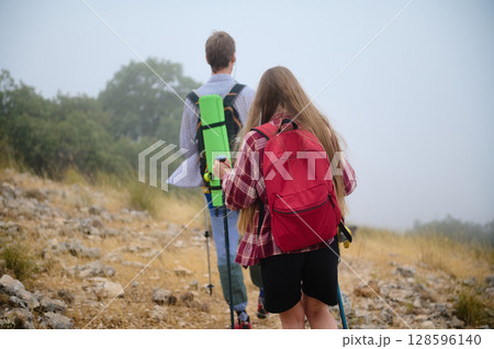 Two Hikers Enjoy Outdoor Adventure in a Scenic Mountain Landscape 128596140