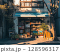 Charming Bookstore With Colorful Displays and Sunlight in a Quiet Urban Street During Late Afternoon 128596317