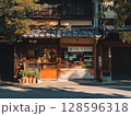 Traditional Japanese Shopfront With Wooden Architecture and Greenery on a Quiet Street in Kyoto During Golden Hour Lighting 128596318