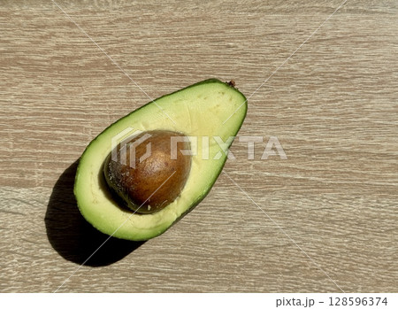 juicy ripe avocado cut in half on a monochrome background. High quality photo juicy ripe avocado cut in half on a monochrome background. High quality photo 128596374
