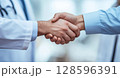 Hands Shaking in a Professional Setting Between a Doctor and a Client During a Consultation 128596391