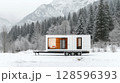 Modern Mobile Cabin Set in a Snowy Mountain Landscape With Pine Trees Surrounding 128596393