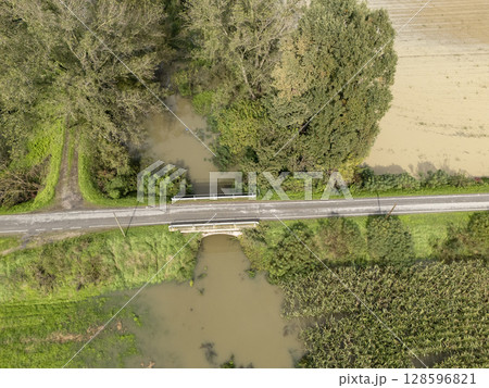 Flooded farmlands by the river swollen bursting it banks creating disasters for farmers, Italy Flooded farmlands by the river swollen bursting it banks creating disasters for farmers, Italy 128596821