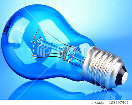 Transparent electric bulb on blue background Transparent electric bulb on blue background 128597401