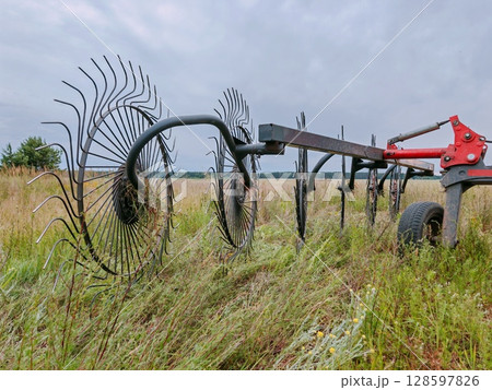 Agricultural machinery, wheel-finger rake. close-up. tractor-mounted rakes. 128597826
