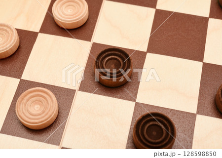 Wooden checkers on the board. The board game checkers. 128598850