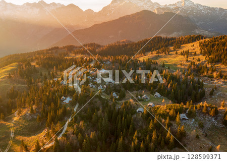 Mountain village in Alps, wooden houses at sunset, Velika Planina, Kamnik, Slovenia 128599371