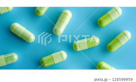 Green and White Medical Pills Arranged on a Vivid Blue Background, Healthcare Concept 128599959