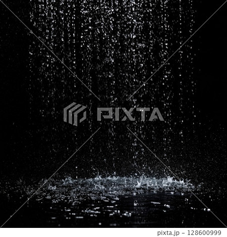 Falling Rain Drops on Dark Surface 128600999