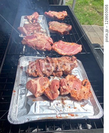 Juicy barbecue meat on the grill, close view, summer barbecue bliss background Juicy barbecue meat on the grill, close view, summer barbecue bliss background 128603008