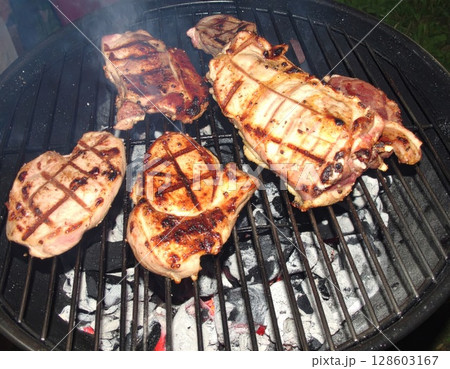Juicy barbecue meat on the grill, close view, summer barbecue bliss background 128603167