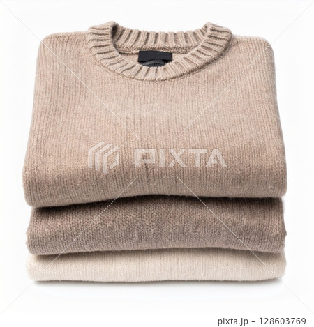 Stack of Beige Knit Sweaters on White Background 128603769