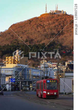 【縦構図、ロゴ運転手ぼかし済】紅葉している函館山を背に走る函館市電 函館市 【縦構図、ロゴ運転手ぼかし済】紅葉している函館山を背に走る函館市電 函館市 128607128