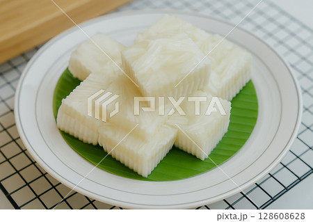 AI generated traditional Thai coconut jelly dessert with soft coconut flesh arranged on banana leaf in clean close up view with natural lighting and fresh texture 128608628