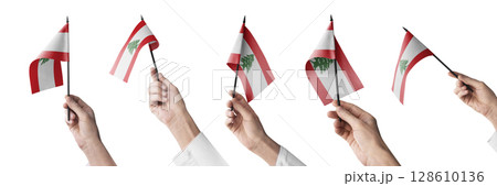 The Lebanon flag in hand in different angles on a white background 128610136