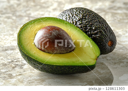 Perfectly Ripened Avocado Half on Marble Surface Perfectly Ripened Avocado Half on Marble Surface 128611303
