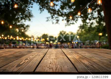 Lively Outdoor Scene with Wooden Table and Lights 128611399
