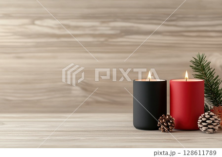 Two candles are lit on a wooden table Two candles are lit on a wooden table 128611789