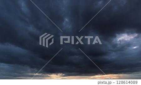 The dark sky, heavy with swirling clouds, signals an impending windstorm, highlighting the dramatic changes in weather and the immense power of nature. 128614089