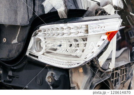 broken rear car headlight, broken headlight close up. Consequences of an accident broken rear car headlight, broken headlight close up. Consequences of an accident 128614870