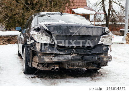The rear of the car is smashed. The headlights and brake lights of the car are smashed. The trunk and bumper are dented. The aftermath of an accident 128614871