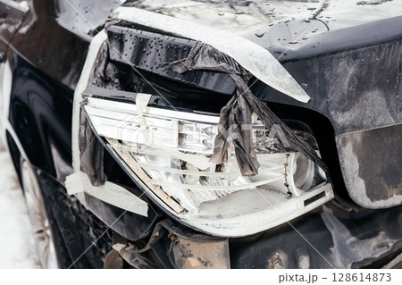 broken rear car headlight, broken headlight close up. Consequences of an accident broken rear car headlight, broken headlight close up. Consequences of an accident 128614873