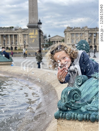 Smiling Child Playing with Fountain Water in City Square Smiling Child Playing with Fountain Water in City Square 128615040