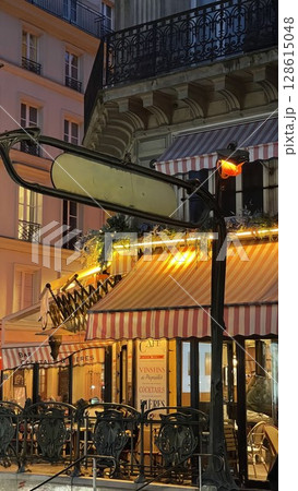 Charming Night View of a Parisian Cafe with Awning Charming Night View of a Parisian Cafe with Awning 128615048