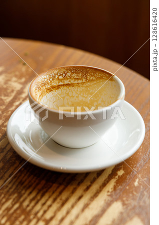 Empty cup of hot milk latte coffee on table by the window. 128616420