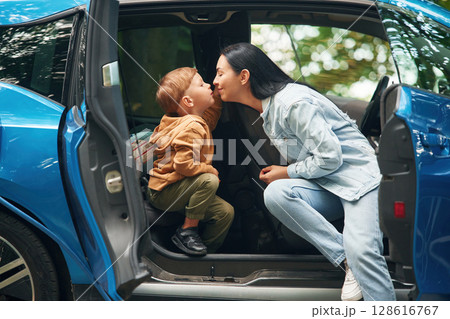 Mother with her little son are in the modern car, having fun Mother with her little son are in the modern car, having fun 128616767